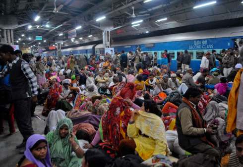 Passengers crowd together at a platform after part of a railing from a bridge collapsed at Allahabad railway station